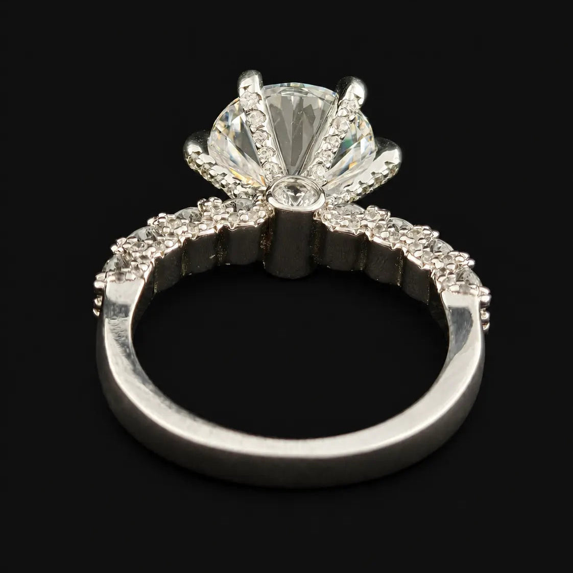 Detailed underside view of round solitaire ring showing hidden halo pave basket and 6 claw prongs