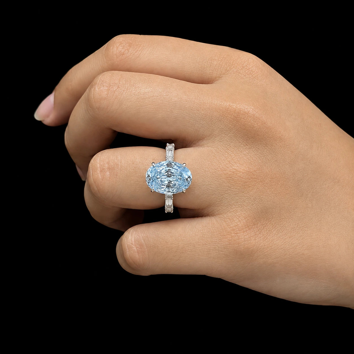 blue oval Rose cut engagement ring with baguette band worn on model 