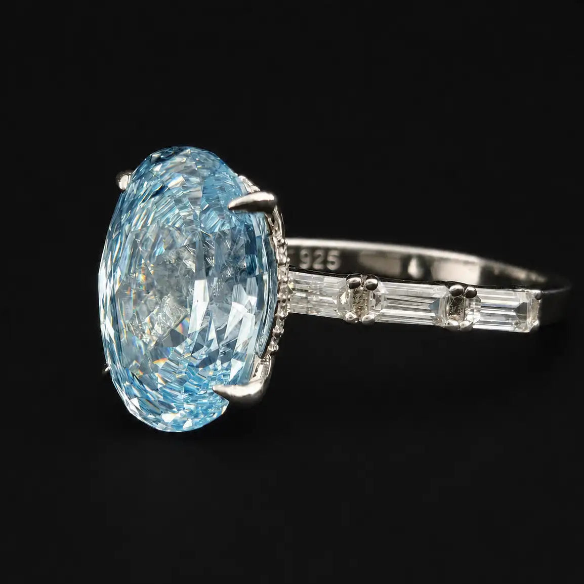 Side view of light blue oval rose cut aquamarine ring showing 925 hallmark stamp and channel set baguette side stones