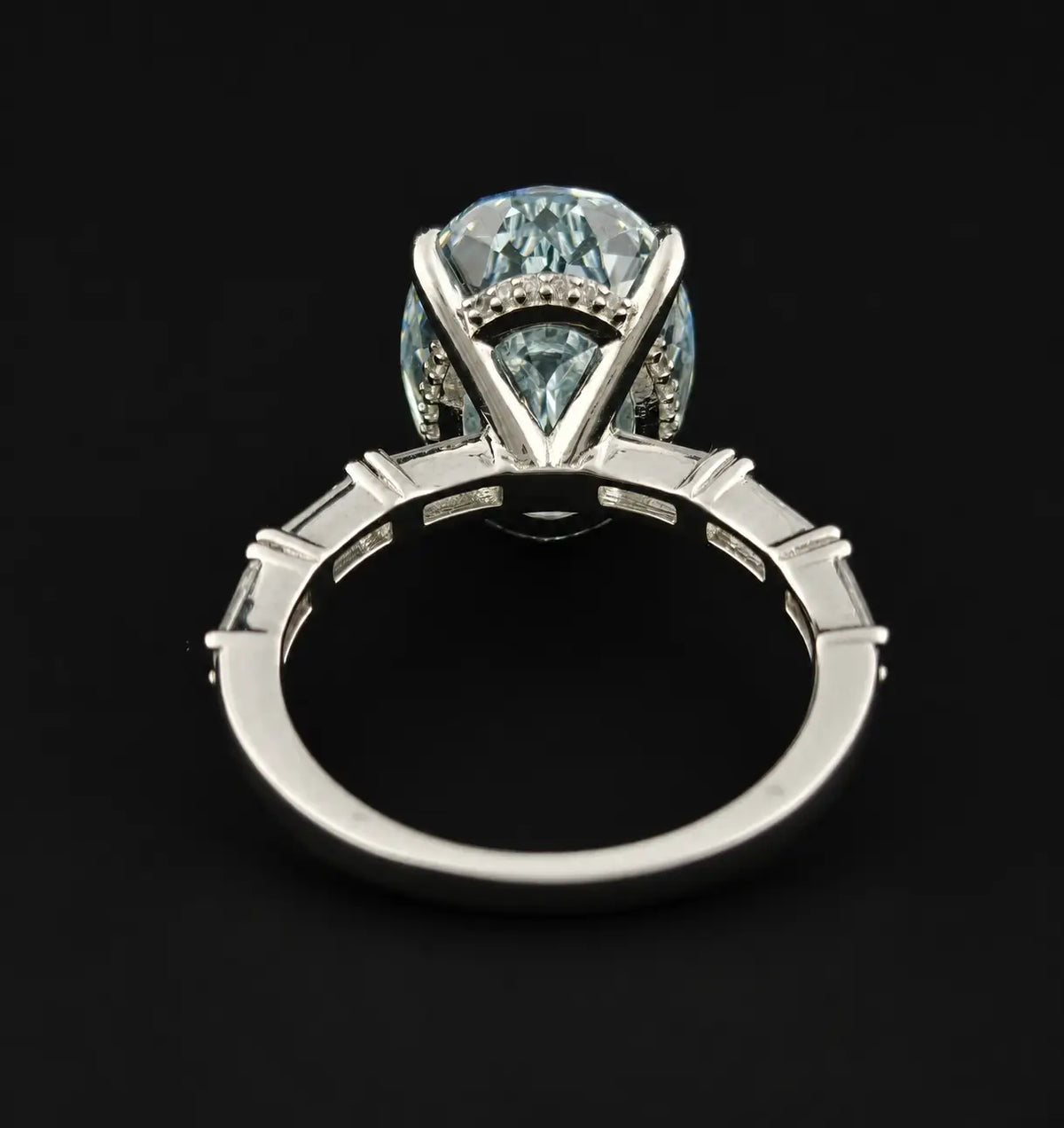 Underneath view of oval Rose Cut solitaire ring showing cathedral bridge and micro pave hidden halo