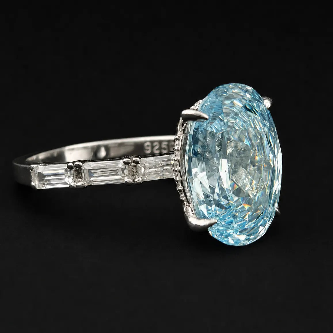 Perspective angle of blue oval rose cut gemstone ring with 4 claw prongs