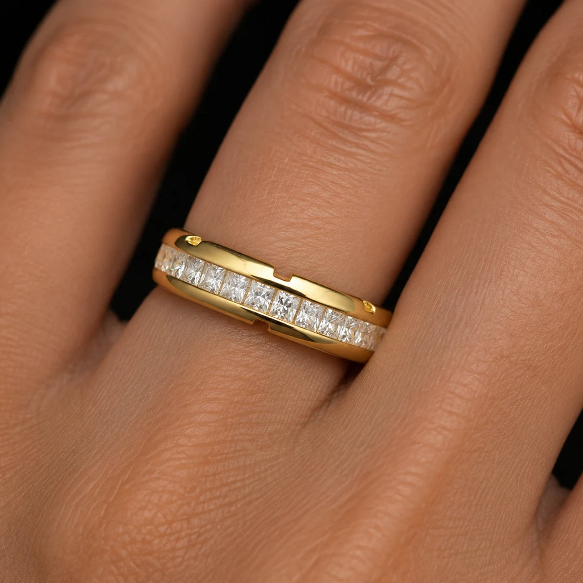 channel set princess cut eternity band worn on finger